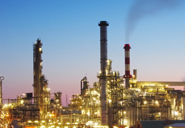 Oil and gas refinery at twilight with reflection - factory - petrochemical plant